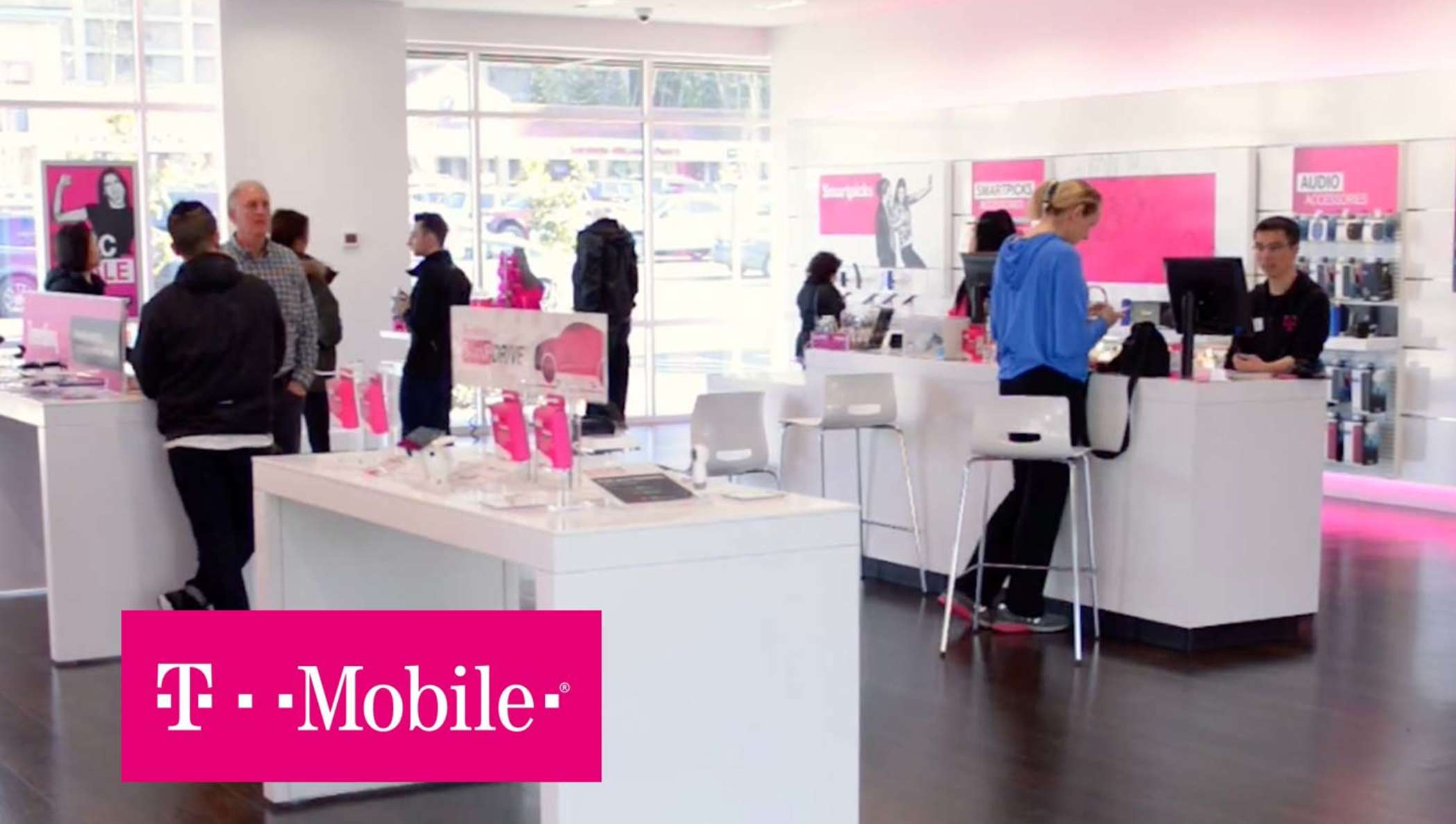 A T-mobile storefront with employees helping customers.